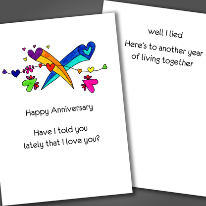 Funny anniversary card with two hearts shooting across the front of the card. Inside the card is a funny joke that says I lied about loving you.
