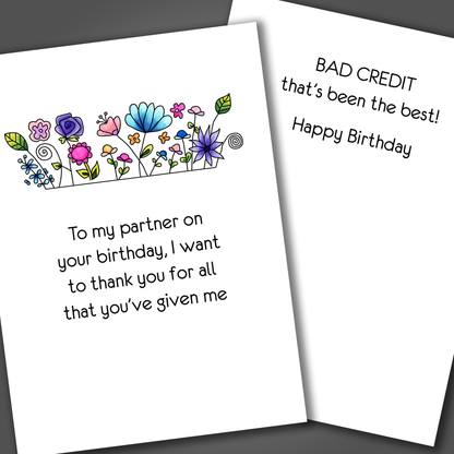 Cute happy birthday card with colorful flowers on the front of the card. Inside of the card is a funny joke about bad credit and ends with happy birthday.