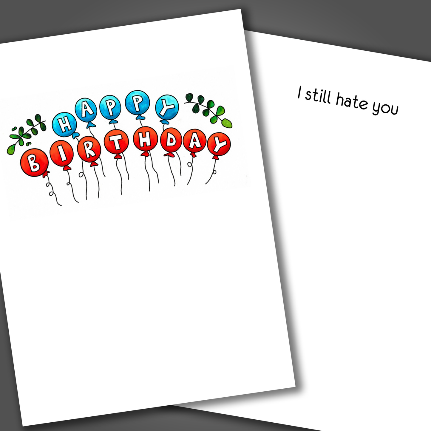 Funny happy birthday card with red and blue balloons drawn on the front of the card. Inside the card is a funny joke inside card that says I still hate you.