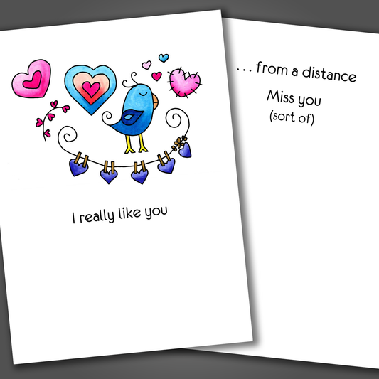 Funny I miss you card with hearts and a blue bird drawn on the front of the card. Inside the card is a funny joke that ends in miss you (sort of).